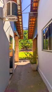 a hallway of a building with a potted plant and a window at Pousada Rancho Dona Lú Comfort in Pereira Barreto