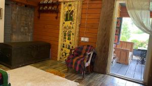 a room with a chair and a door to a porch at Chalet de Bella in Terlo