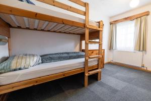 a bedroom with two bunk beds and a window at Ferienwohnung am Abbrandtnergut 