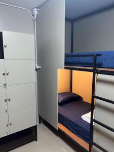 a room with two bunk beds and a closet at Mari hostel in Koh Tao