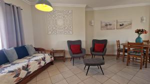 a living room with a couch and chairs and a table at Ria's Birds in Cabanas de Tavira +24 photos