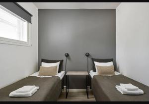 two beds sitting next to each other in a room at Holiday Club Vierumäki Apartments in Vierumäki
