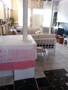 a living room with a table and a couch at Elmadel Coffee Gardens 4Bed Rustic Wooden House in Machakos