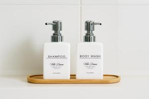 deux bouteilles de shampoing et une boîte sur une étagère en bois dans l'établissement Villa Diana, à Castelnuovo di Garfagnana