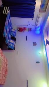 a room with several beds and a ceiling with blue lights at kanak homestay in Ayodhya