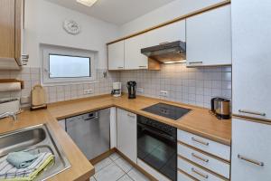 a kitchen with a sink and a stove top oven at Gästehaus Binz-Meyer Fewo Paulsberg in Lieser