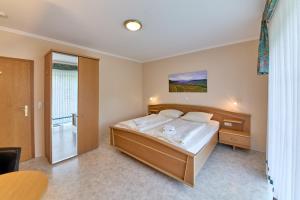 a bedroom with a large bed and a shower at Gästehaus Binz-Meyer Fewo Paulsberg in Lieser