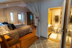 a bedroom with a bed and a room with a bathroom at Private House by the River in Rovaniemi