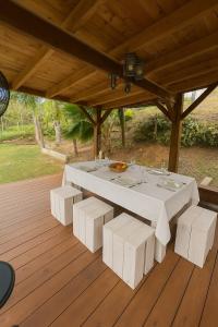 a white table and chairs on a wooden deck at Fisherman Hut in Le Gosier