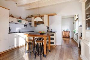a kitchen with a wooden table and stools at Family rooms in central, historic Gouda in Gouda