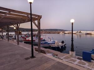 a group of boats are docked at a dock at cozystudio Chezmoi in Chios