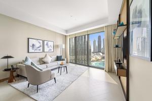 a living room with a couch and a large window at Address Residence Dubai Opera 25 by Luxstay Holiday Homes in Dubai