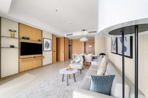 a living room with a couch and a tv at Address Residence Dubai Opera 25 by Luxstay Holiday Homes in Dubai