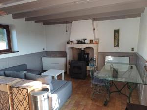 a living room with a couch and a glass table at Exceptional cottage in Tournus
