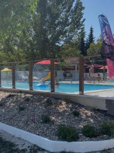 a swimming pool with people playing in it at Sunny Resort in Donji Karin