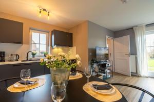 a kitchen and dining room with a table with wine glasses at Kleine Bö 2 in Tönning