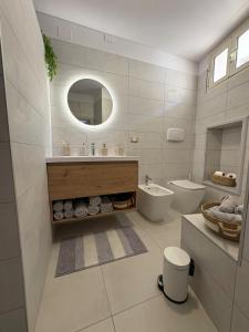 a bathroom with a sink and a toilet and a mirror at La chiave della felicita Casoli in Casoli +19 photos