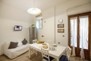 a living room with a white table and a couch at La TERRAZZA in Nunziata