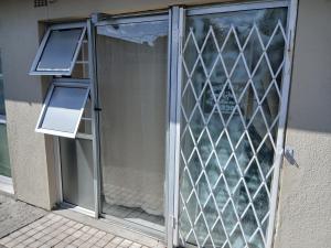 a glass door with two lights on the side of a building at 12 on lake in Parkwood