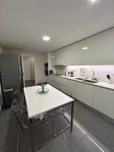 a kitchen with a table and chairs in it at The Place to Stay ! in Póvoa de Santa Iria