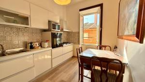 a kitchen with a table and a dining room at Il Segreto del Borgo Vaticano in Rome