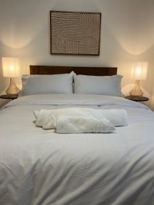 a large white bed with two lamps on both sides at NEW 2 Bed Town Centre Secure Free Parking in Newark upon Trent