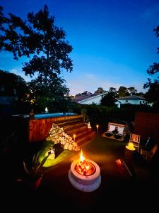 a fire pit in the middle of a yard at night at "Instant Zen" Chambre double - 15 min Merignac airport et Bordeaux in Saint-Médard-en-Jalles