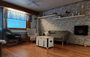 a living room with a couch and a fireplace at Apartment Kallio, Rovaniemi Suomi in Hirvas
