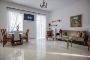 a living room with a couch and a table at Argo Luxury House in Volos