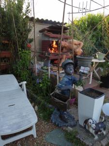 a statue of a boy in front of a fire oven at Maison d'hôte avec jardin in Le Mans