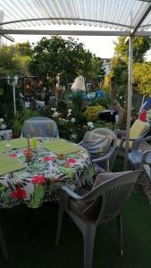 a table and chairs with a table cloth on it at Maison d'hôte avec jardin in Le Mans