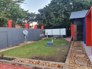 a garden in front of a building with a fountain at Stofberg Guest House in Brits