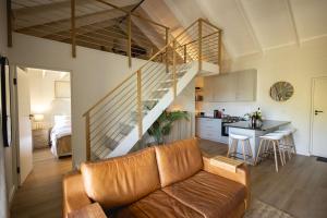 a living room with a couch and a kitchen at Aurora Valley Escape Apartment 9 in Hermanus