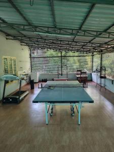 a large room with a ping pong table in it at Royal Green Homestay Taliparamba in Taliparamba