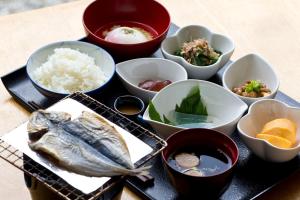 a tray of food with a fish and bowls of food at Zen no Yu in Kawazu