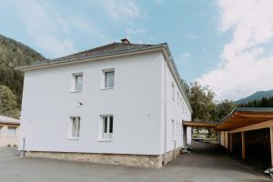 a large white building with a garage at Kupferdachl in Sankt Lambrecht
