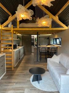 a living room with a couch and a loft bed at Gîte Meunier, tu dors in Vaux-sur-Sûre +11 photos