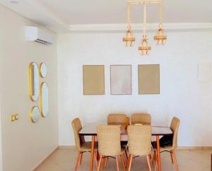 a dining room with a table and chairs at Appartement avec piscine taghazout imi Ouaddar in Agadir nʼ Aït Sa