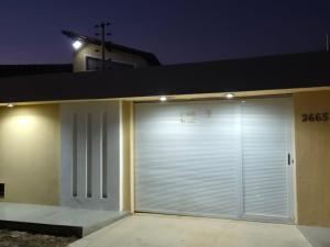 a garage with closed doors on a house at night at Praia Peito de Moça in Luis Correia