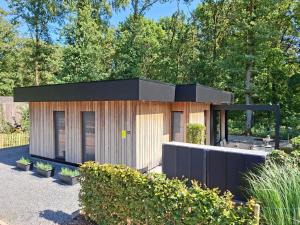 a small house with a black roof at Theressa - Free Wifi en Netflix in Zutendaal