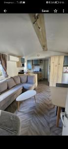 a living room with a couch and a table at WOW Holidays - 8 Person, 5 Star Mobile-Home with Terrace in Gastes +21 photos