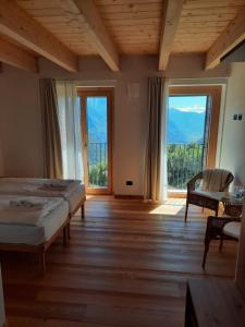 a bedroom with two beds and a large window at Convivio San Bernardo 