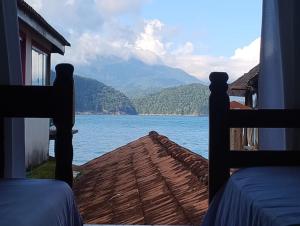 a view of a lake from a room with two beds at hostel Boa Onda Trindade in Paraty