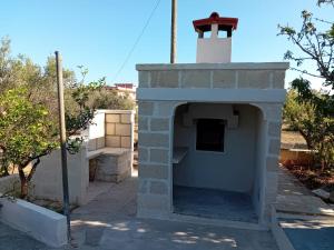 an outdoor brick oven with a tower on top at Villa Mina in Serranova