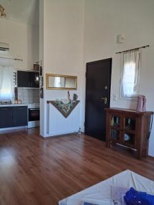 a living room with a kitchen and a door in a room at La Rosa in Paliouriá +15 photos