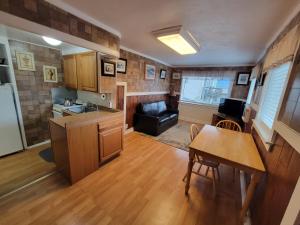 a kitchen and living room with a table and a couch at Downtown Juneau Gold Street Apartments in Juneau
