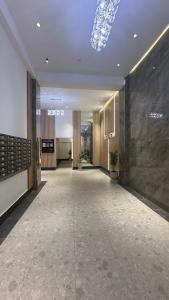 a hallway of a building with a large lobby at Luxury Apartment in City Center in Dushanbe