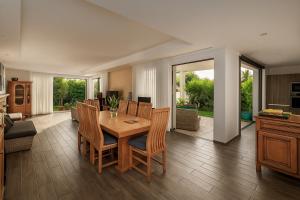 a kitchen and dining room with a table and chairs at Serenity in La Gaulette