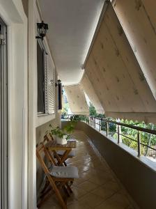 a balcony with two chairs and a table on it at Graci Apartments in Sarandë