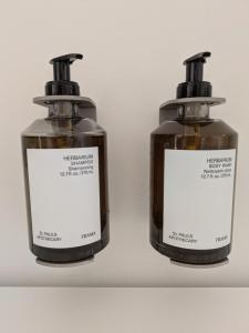two bottles of soap sitting on a shelf at Herman in Bruges +7 photos